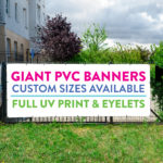 GIANT BANNERS Giant banner on a fence with message that advertises custom size PVC banners for dale