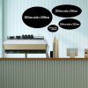 A collection of 4 oval shaped chalkboards hanging from a wall