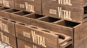 Many condiment holders made from wood with engraved logos for the brand Vital