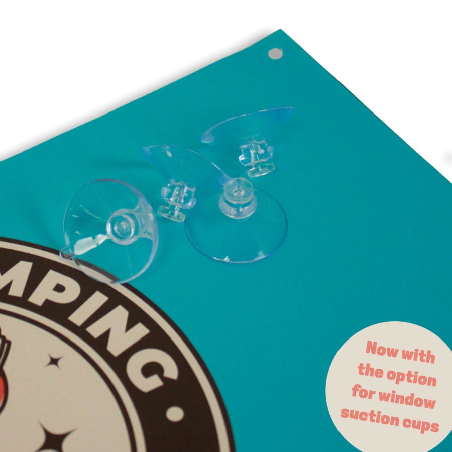 A small plastic suction cup mounted to a poster, ready for window mounting