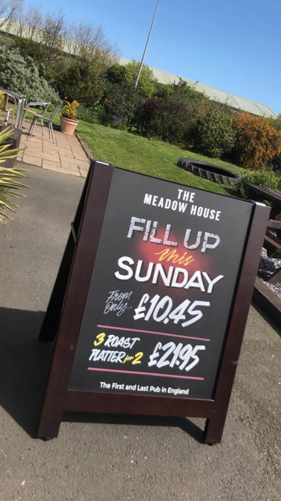 Pavement sign with chalkboards that slot out and can be reversed showing optional printed side outside of a pub