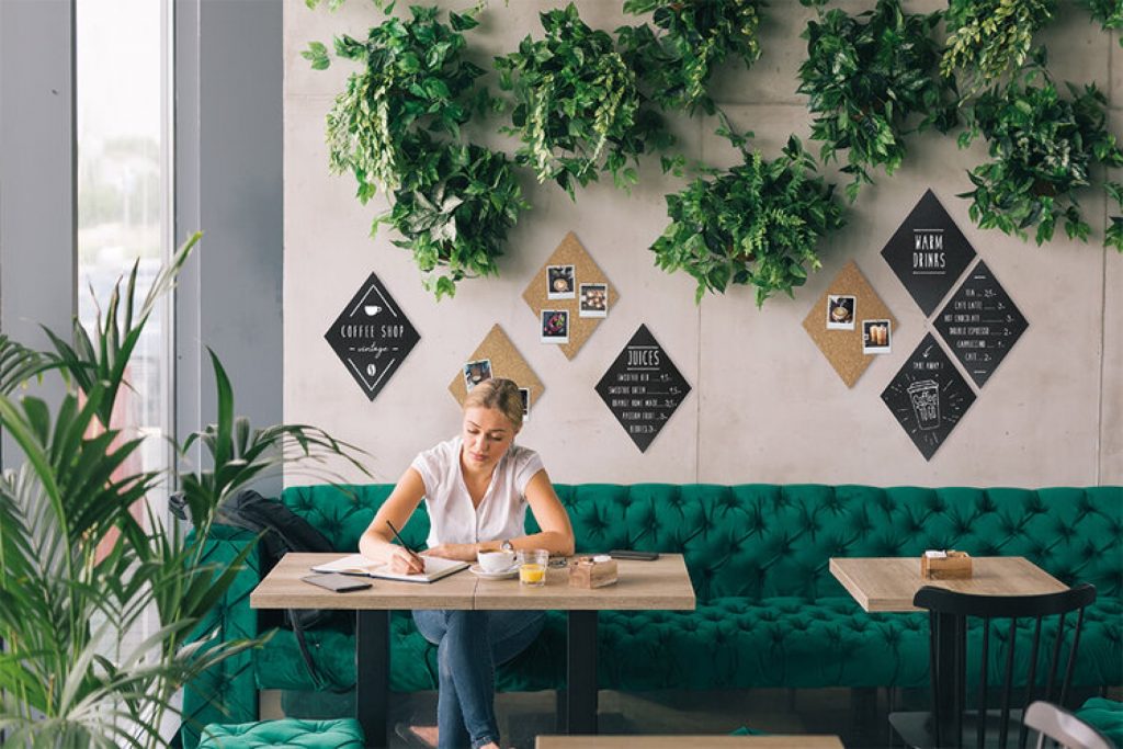 A vinyl poster with personalised promotion printed to one side in situ in a cafe