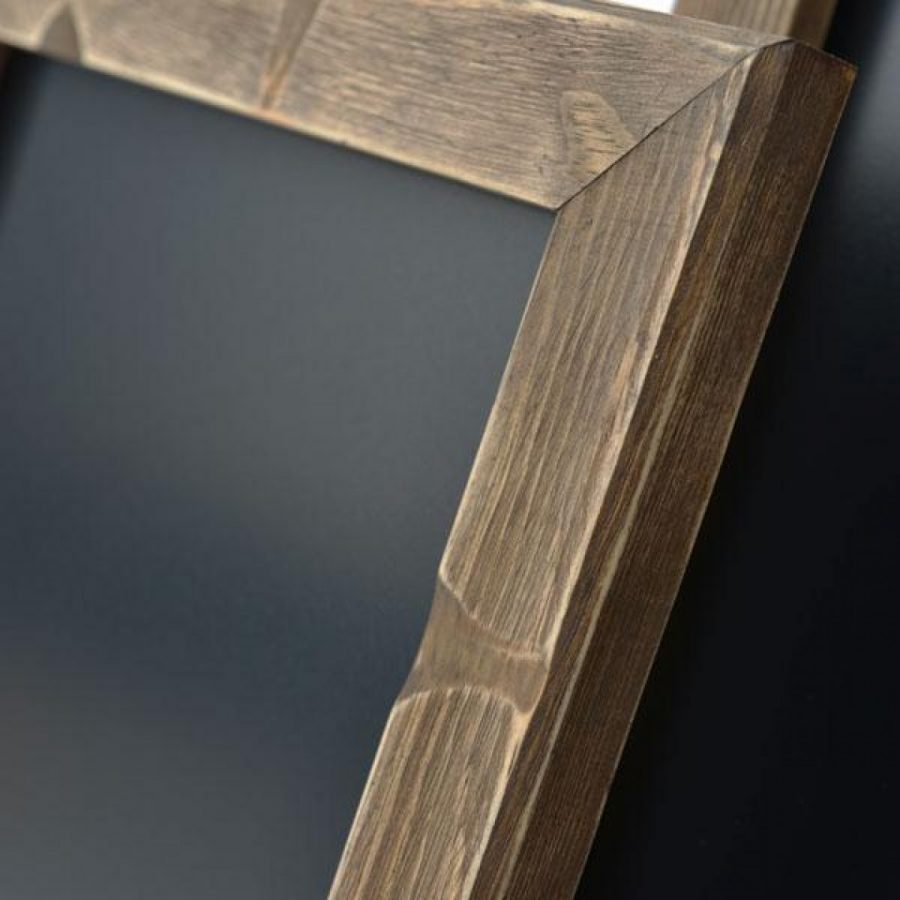Closeup of distressed finish on a wooden sliding poster frame