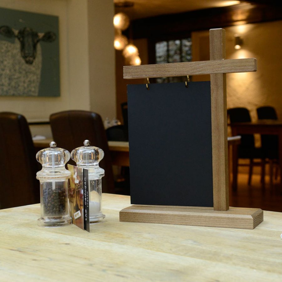 A chalkboard table talkers with swinging action and wooden base