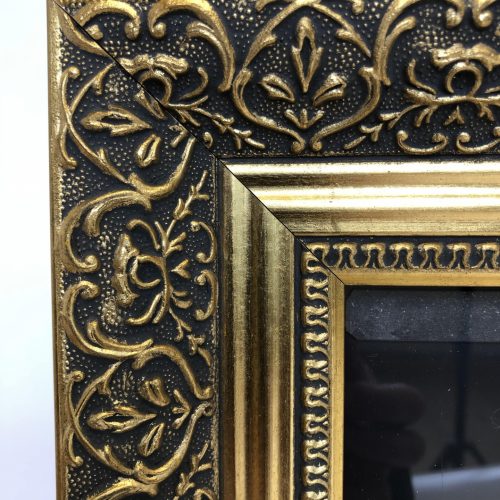 Wooden poster frame with gold frame closeup of detail