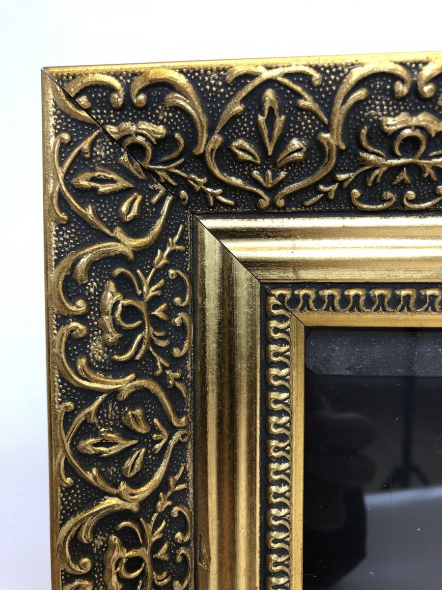 Wooden poster frame with gold frame closeup of detail