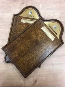 Naval themed menu holders, with small brass labels and dark coloured wood