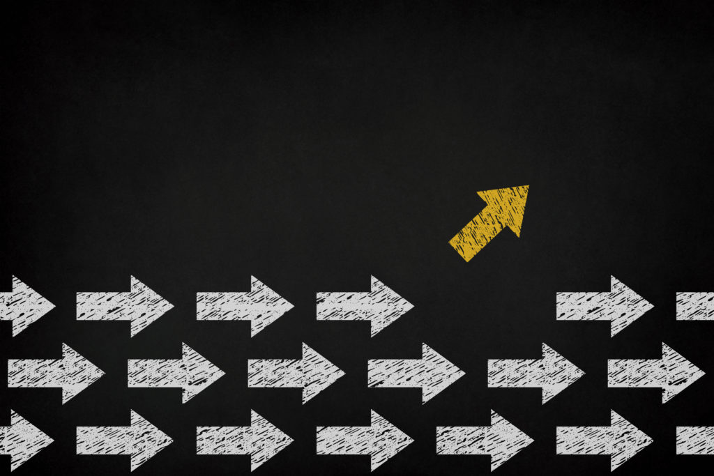 Chalkboard Buying Guide - chalkboard art showing chalk arrows, with one yellow arrow facing up and several white arrows facing forward