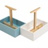 A painted wooden box holding condiments natural wood handle