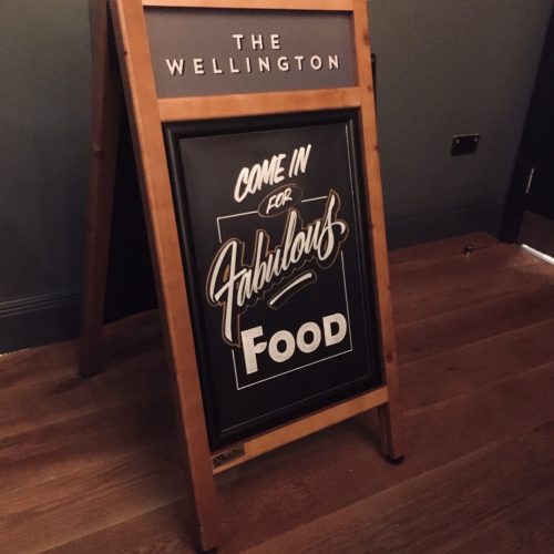 Standard Plus wooden sign with chalkboard display in situ at a pub