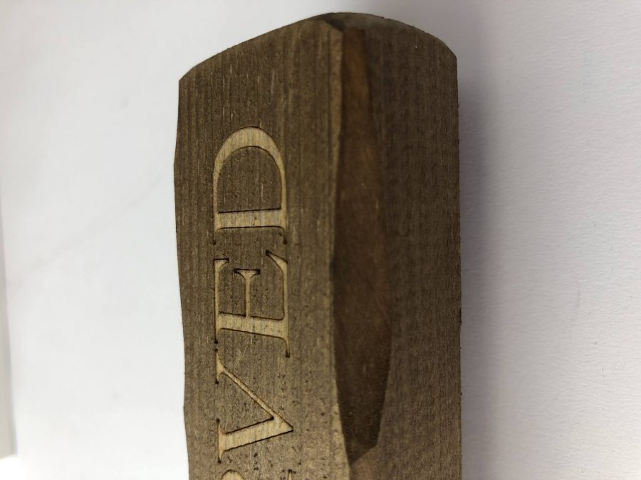 A wooden block with Reserved engraved for table reservations